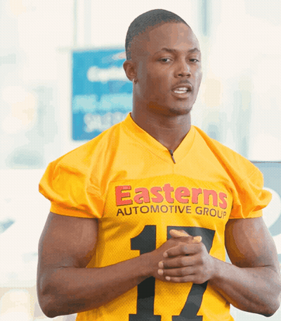 Man In Yellow Easterns Automotive Group Jersey With Hands Folded GIF