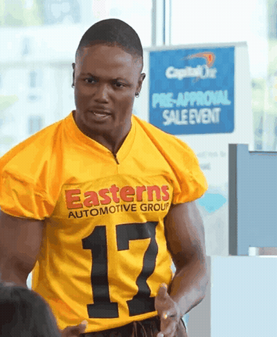 Man In Yellow Easterns Automotive Group Shirt GIF