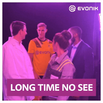 Man In Yellow Evonik Jersey Talks To Woman GIF