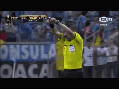 Man In Yellow FIFA Shirt In Front Of DACA Sign GIF