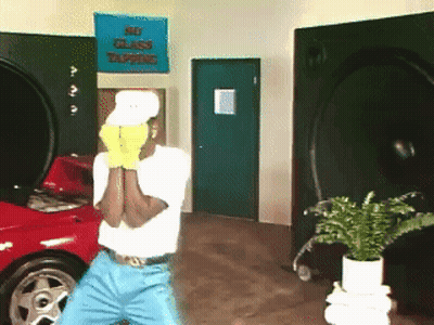 Man In Yellow Gloves In Front Of No Glass Tapping Sign GIF