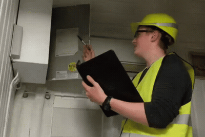 Man In Yellow Hard Hat And Safety Vest Holding Clipboard GIF