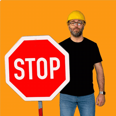 Man In Yellow Hard Hat Holding Stop Sign GIF