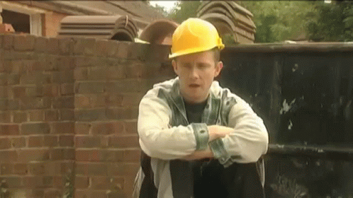 Man In Yellow Hard Hat Sitting Arms Crossed GIF