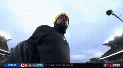 Man In Yellow Hat At Microphone In Stadium GIF