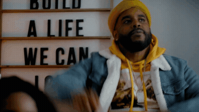 Man In Yellow Hat With Sign Build A Life We Can GIF