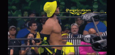 Man In Yellow Hat Wrestling Ring With Fans GIF