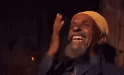 Man In Yellow Headband Laughing Covering Face GIF