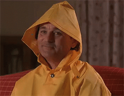 Man In Yellow Hooded Raincoat Smiling GIF