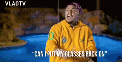 Man In Yellow Hoodie Putting On Glasses GIF