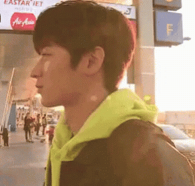 Man In Yellow Hoodie With Eastar Jet Sign GIF