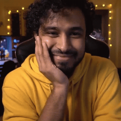 Man In Yellow Hoodie With Hand On Face GIF