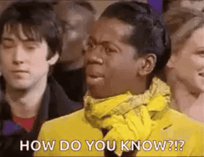 Man In Yellow Jacket And Scarf Before Crowd GIF