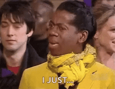 Man In Yellow Jacket And Scarf Making Funny Face In Crowd GIF