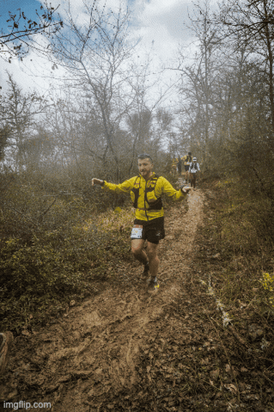 Man In Yellow Jacket And Shorts Running GIF