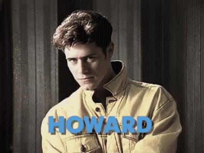 Man In Yellow Jacket By Wall Saying Howard GIF