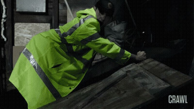 Man In Yellow Jacket Crawling GIF