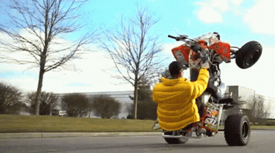 Man In Yellow Jacket Doing Trick On Four Wheeler 67 GIF