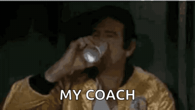 Man In Yellow Jacket Drinking Water Saying My Coach GIF