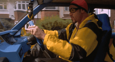 Man In Yellow Jacket Driving Blue Car GIF