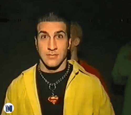 Man In Yellow Jacket Giving Peace Sign GIF