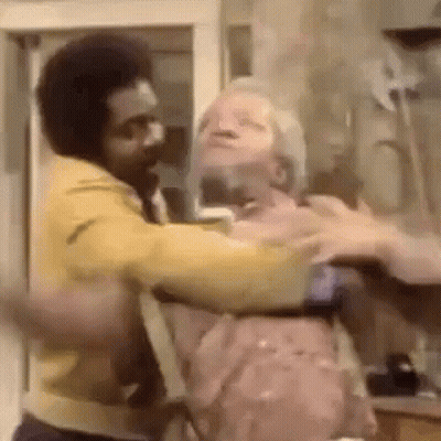 Man In Yellow Jacket Holding Another Man In Yellow Jacket GIF