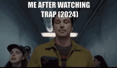Man In Yellow Jacket Holding Gun Eyes Closed GIF