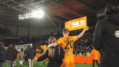 Man In Yellow Jacket Next To Man In Orange Shirt GIF