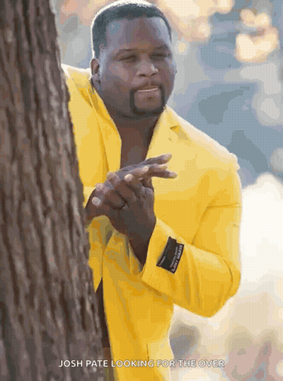 Man In Yellow Jacket Peeking Behind Tree GIF