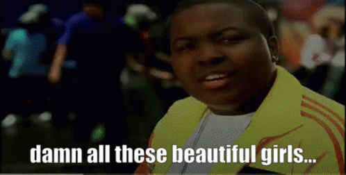 Man In Yellow Jacket Saying Damn All These Beautiful Girls GIF
