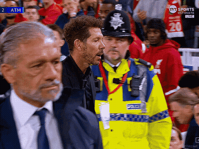 Man In Yellow Jacket Saying Police In Crowd GIF