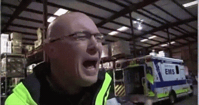 Man In Yellow Jacket Screaming In Front Of EMS Ambulance GIF