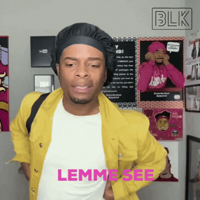 Man In Yellow Jacket Standing By Blk Sign GIF