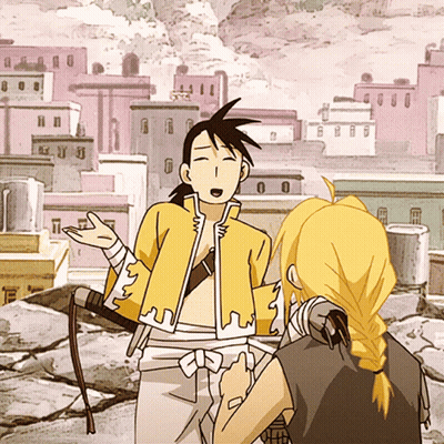 Man In Yellow Jacket Standing Next To Another Man GIF