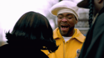 Man In Yellow Jacket Talking To Another Man GIF