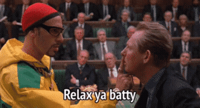Man In Yellow Jacket Talking To Another Man With Relax Ya Batty GIF