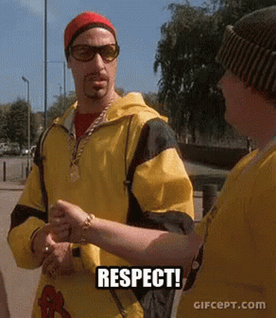 Man in Yellow Jacket Talking to Man in Sunglasses and Red Hat Respect