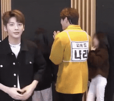 Man In Yellow Jacket With NC Tag On Back GIF