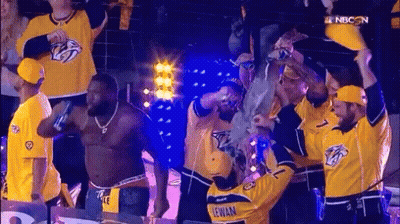 Man In Yellow Jersey Lewan Surrounded By People GIF