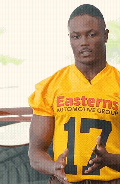 Man In Yellow Jersey Saying Easterns Automotive Group GIF