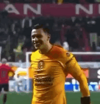 Man In Yellow Jersey Smiling On Soccer Field GIF