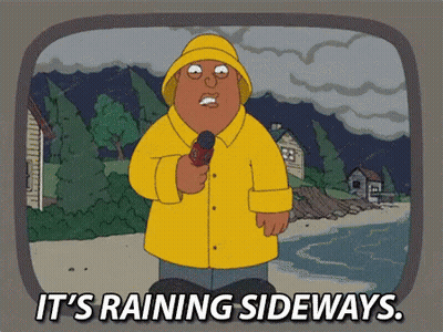 Man In Yellow Raincoat Holding Microphone It's Raining Sideways GIF