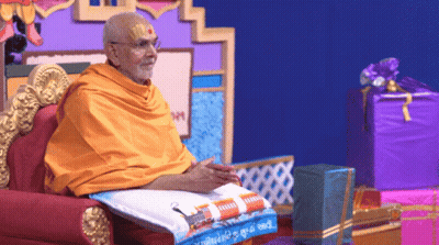 Man In Yellow Robe On Chair With Purple Box GIF
