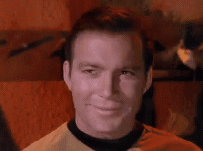 Man In Yellow Shirt And Black Collar Smiling GIF