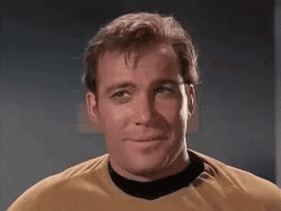 Man In Yellow Shirt And Black Collar Smiling GIF