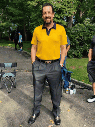 Man In Yellow Shirt And Black Pants In Parking Lot GIF