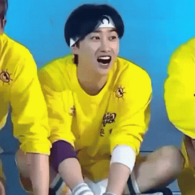 Man In Yellow Shirt And Headband Laughing On Floor GIF