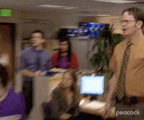 Man in Yellow Shirt and Tie in Front of Computer