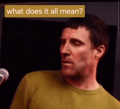 Man In Yellow Shirt At Microphone Saying What Does It All Mean GIF