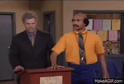 Man In Yellow Shirt At Podium Man In Suit Behind GIF